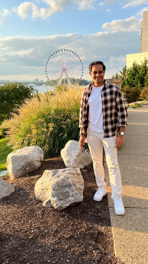 Ishan Basak at the National Harbor waterfront with the Capital Wheel behind him